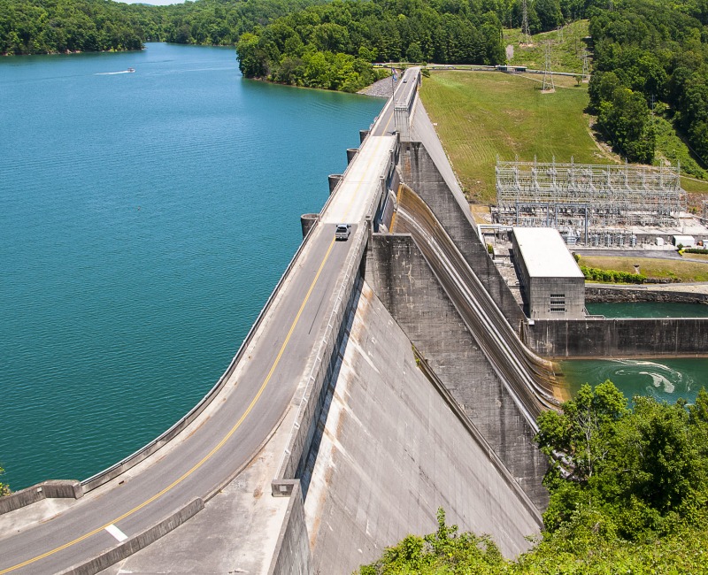 landscapes composed of a dam and an road and an car