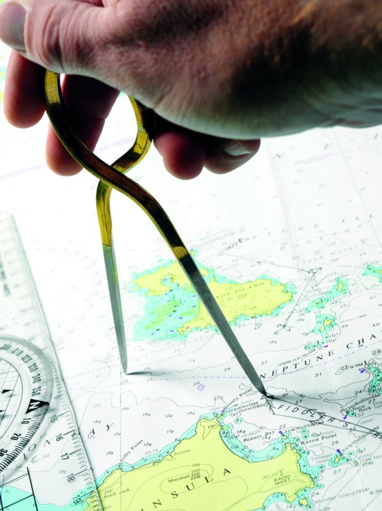 Navigation position plotting, with hand dividers on a nautical chart.